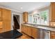 Kitchen featuring granite countertops, stainless appliances, and natural wood cabinetry at 4517 Gates St, Raleigh, NC 27609