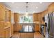 Kitchen with stainless appliances, an island, and a window over the sink at 4517 Gates St, Raleigh, NC 27609