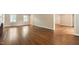 Spacious living room with hardwood floors, plantation shutters and neutral paint at 4517 Gates St, Raleigh, NC 27609