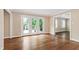 Bright living room featuring hardwood floors, a patio and plantation shutters at 4517 Gates St, Raleigh, NC 27609