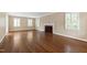Elegant living room featuring hardwood floors, a fireplace and plantation shutters at 4517 Gates St, Raleigh, NC 27609