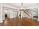 Spacious living room with hardwood floors, stairs and chandelier at 4517 Gates St, Raleigh, NC 27609