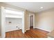 Room with hardwood floors, closet with bi-fold doors, and doorway to another room at 4517 Gates St, Raleigh, NC 27609