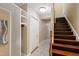 Basement staircase featuring wooden steps and tile flooring in the hallway at 4517 Gates St, Raleigh, NC 27609
