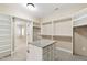 Spacious walk-in closet with custom shelving and central island with drawers at 4517 Gates St, Raleigh, NC 27609