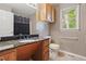 Bathroom featuring a granite countertop, wooden cabinetry, toilet and window at 5105 Baywood Forest Dr, Knightdale, NC 27545