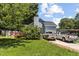 Home exterior with driveway, lush lawn and mature trees in backyard at 5105 Baywood Forest Dr, Knightdale, NC 27545