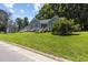 Charming blue home featuring a well-manicured front yard and inviting entrance at 5105 Baywood Forest Dr, Knightdale, NC 27545