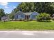 Charming blue home featuring a well-manicured front yard and inviting entrance at 5105 Baywood Forest Dr, Knightdale, NC 27545