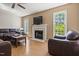Cozy living room with a fireplace, ceiling fan and two bright windows at 5105 Baywood Forest Dr, Knightdale, NC 27545