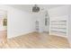 Bright bedroom featuring a window, built-in shelving, and light flooring at 5217 West Oaks Dr, Fuquay Varina, NC 27526