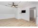 A versatile bonus room with wood floors, fan, and a TV area, perfect for entertainment at 5217 West Oaks Dr, Fuquay Varina, NC 27526