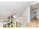 A bright hallway showcases a vaulted ceiling with a railing overlooking a lower floor at 5217 West Oaks Dr, Fuquay Varina, NC 27526