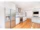 Bright kitchen features stainless steel appliances, stone counters and unique metal shelving at 5217 West Oaks Dr, Fuquay Varina, NC 27526
