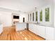 Contemporary kitchen featuring bright lighting, wine cooler, white cabinets and hardwood floors at 5217 West Oaks Dr, Fuquay Varina, NC 27526