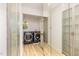 Bright laundry room features modern appliances, wood floor, and natural light from the window at 5217 West Oaks Dr, Fuquay Varina, NC 27526