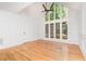 Bright living room with hardwood floors, detailed wall molding, and a large window at 5217 West Oaks Dr, Fuquay Varina, NC 27526