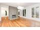 Bright living room with hardwood floors, modern fireplace, and detailed wall molding at 5217 West Oaks Dr, Fuquay Varina, NC 27526