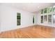 Bright living room with hardwood floors, detailed wall molding, and large windows at 5217 West Oaks Dr, Fuquay Varina, NC 27526