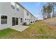Row of new townhomes with a shared, grassy backyard and a patio area at 67 Little Leaf Ln # 98, Clayton, NC 27527