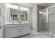 Well-lit bathroom featuring double sink vanity and glass-enclosed shower at 67 Little Leaf Ln # 98, Clayton, NC 27527