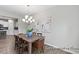 Dining area with a wooden table, chandelier, and artwork creating a welcoming atmosphere at 67 Little Leaf Ln # 98, Clayton, NC 27527