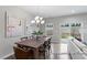 Inviting dining room with modern chandelier, dining table and access to living room at 67 Little Leaf Ln # 98, Clayton, NC 27527