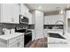 Modern kitchen features stainless steel appliances, white cabinetry, and ample counter space at 67 Little Leaf Ln # 98, Clayton, NC 27527