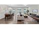 Open-concept living and dining area features modern lighting, neutral colors and sliding glass doors to the backyard at 67 Little Leaf Ln # 98, Clayton, NC 27527
