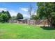 Well-maintained backyard featuring a fenced perimeter, green grass, and mature trees at 73 Lynnville Ct, Lillington, NC 27546