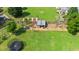 Beautiful backyard featuring a chicken coop, trampoline, storage shed, and well-maintained lawn at 73 Lynnville Ct, Lillington, NC 27546
