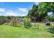 Backyard featuring raised garden beds, perfect for gardening enthusiasts at 73 Lynnville Ct, Lillington, NC 27546