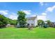 Spacious backyard with a fire pit, a playset, and a deck, perfect for outdoor activities at 73 Lynnville Ct, Lillington, NC 27546