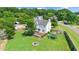 Backyard aerial view featuring a deck, playset, fire pit, and fenced yard for Gathering fun at 73 Lynnville Ct, Lillington, NC 27546