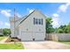 Exterior view of a two-story home with a two-car garage, showcasing its architectural style at 73 Lynnville Ct, Lillington, NC 27546