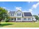 Charming two-story home with solar panels, inviting front porch, and well-manicured lawn at 73 Lynnville Ct, Lillington, NC 27546