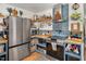 Charming kitchen featuring stainless steel appliances, blue subway tile backsplash, and open shelving at 73 Lynnville Ct, Lillington, NC 27546
