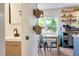 Features view into kitchen with a farmhouse sink, open wooden shelving, and breakfast table at 73 Lynnville Ct, Lillington, NC 27546