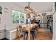 Eat-in kitchen with stainless appliances, beautiful open wooden shelving, and a sun-filled dining area at 73 Lynnville Ct, Lillington, NC 27546