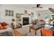 Bright living room with a fireplace, ceiling fan, and comfortable seating at 73 Lynnville Ct, Lillington, NC 27546