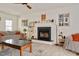 Bright living room with a fireplace, ceiling fan, and comfortable seating at 73 Lynnville Ct, Lillington, NC 27546