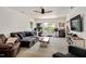 Spacious living room with comfortable seating, a ceiling fan, and abundant natural light at 73 Lynnville Ct, Lillington, NC 27546