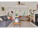 Well-lit living room featuring neutral tones, a fireplace, and cozy seating arrangements at 73 Lynnville Ct, Lillington, NC 27546