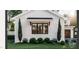 A charming brick exterior detail showcases a black window frame and lush landscaping, enhancing curb appeal at 8014 Penny Rd, Raleigh, NC 27606
