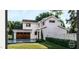 Beautiful two-story home with white siding, brick accents, a two-car garage, and lush landscaping at 8014 Penny Rd, Raleigh, NC 27606