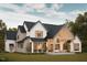 Expansive backyard with a covered patio and outdoor seating area, perfect for entertaining and relaxation at 8016 Penny Rd, Raleigh, NC 27606
