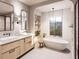 Bright bathroom with double vanity, soaking tub, and large window overlooking the outdoor greenery at 8016 Penny Rd, Raleigh, NC 27606