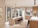Bright dining area featuring a wooden table with seating for eight near the open-concept kitchen at 8016 Penny Rd, Raleigh, NC 27606