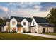 Stunning two-story home with a modern farmhouse aesthetic, complemented by lush green landscaping at 8016 Penny Rd, Raleigh, NC 27606