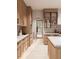 A modern kitchen with light wood cabinets, stainless steel appliances, and a marble countertop island at 8016 Penny Rd, Raleigh, NC 27606